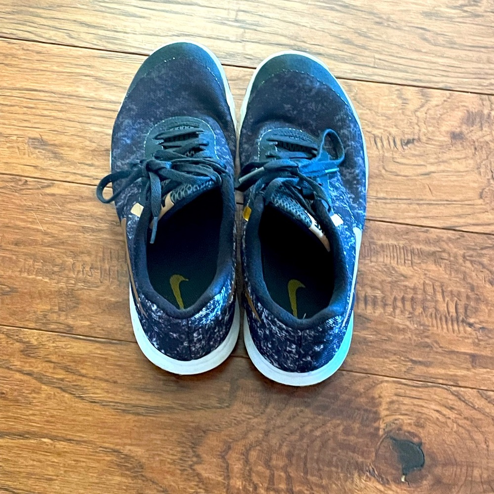 Black and gold Nikes